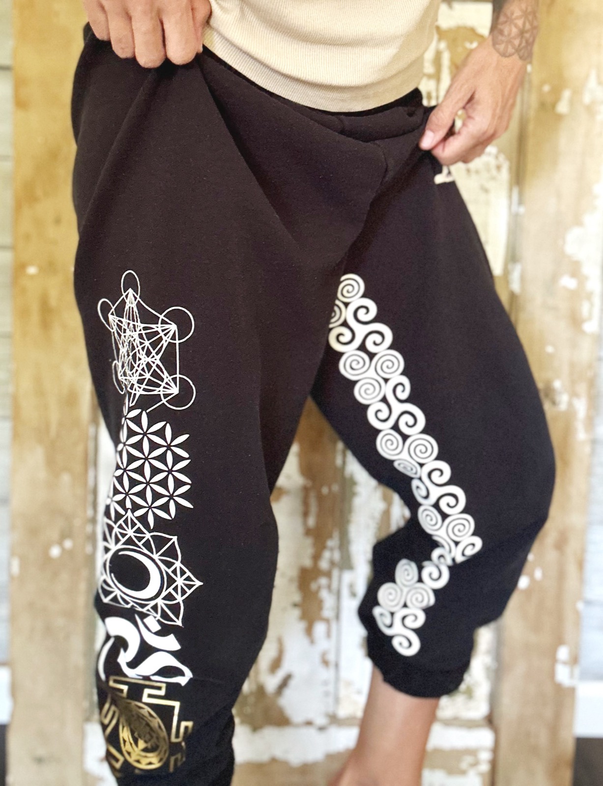 Born to Carry Light sweatpants in black with white sacred geometry symbols down the leg.