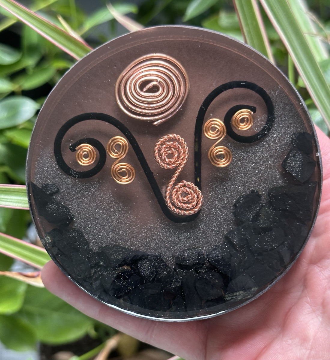 Handmade orgone coaster with copper Aries zodiac symbol set in dark resin with shungite chips