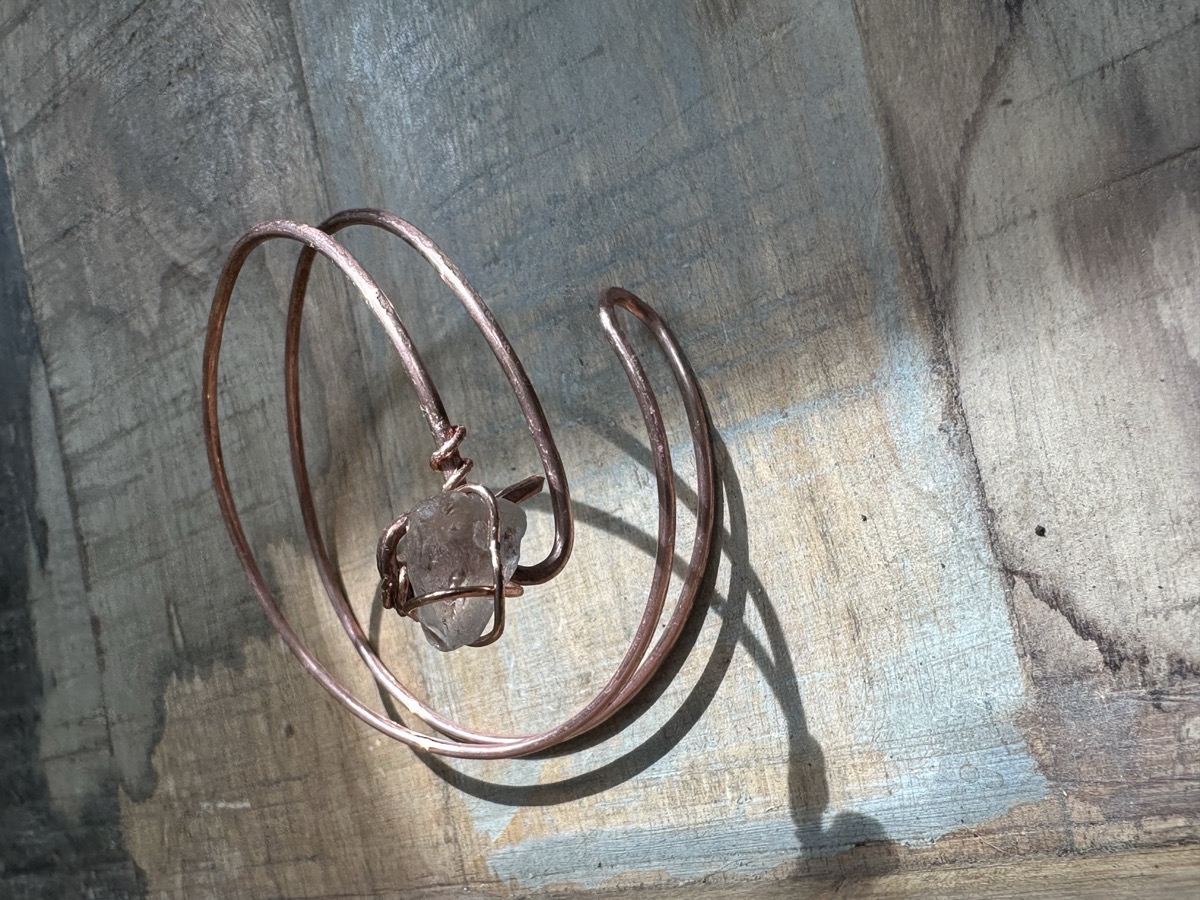 Copper bracelet on wood surface
