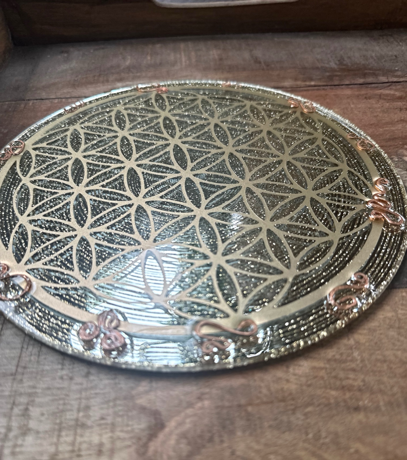 Angled view of Flower of Life charging plate