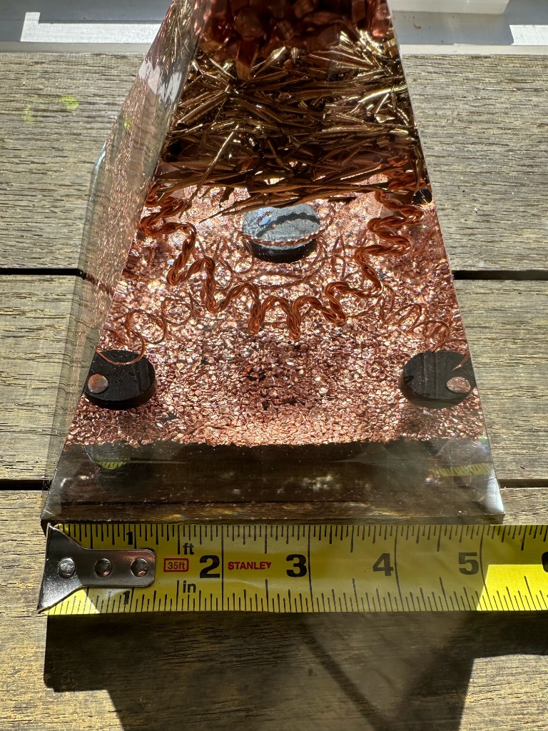 Large orgonite pyramid base depth measurement showing approximately 5 inches