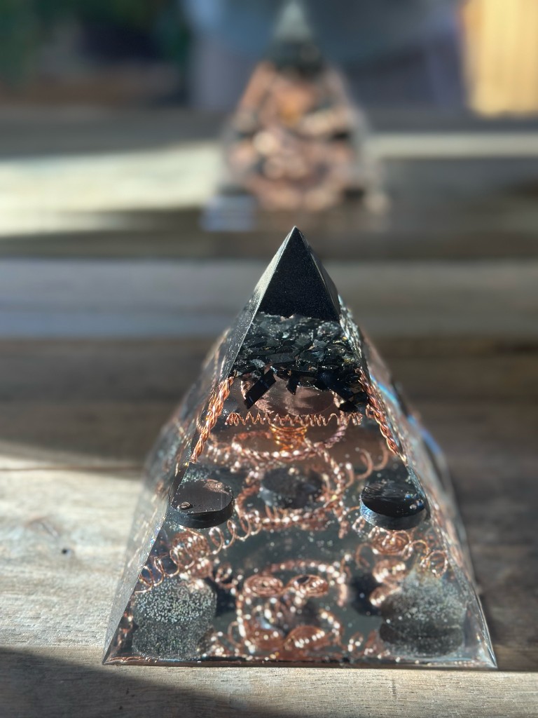 Small orgonite pyramid front view with copper spirals and shungite