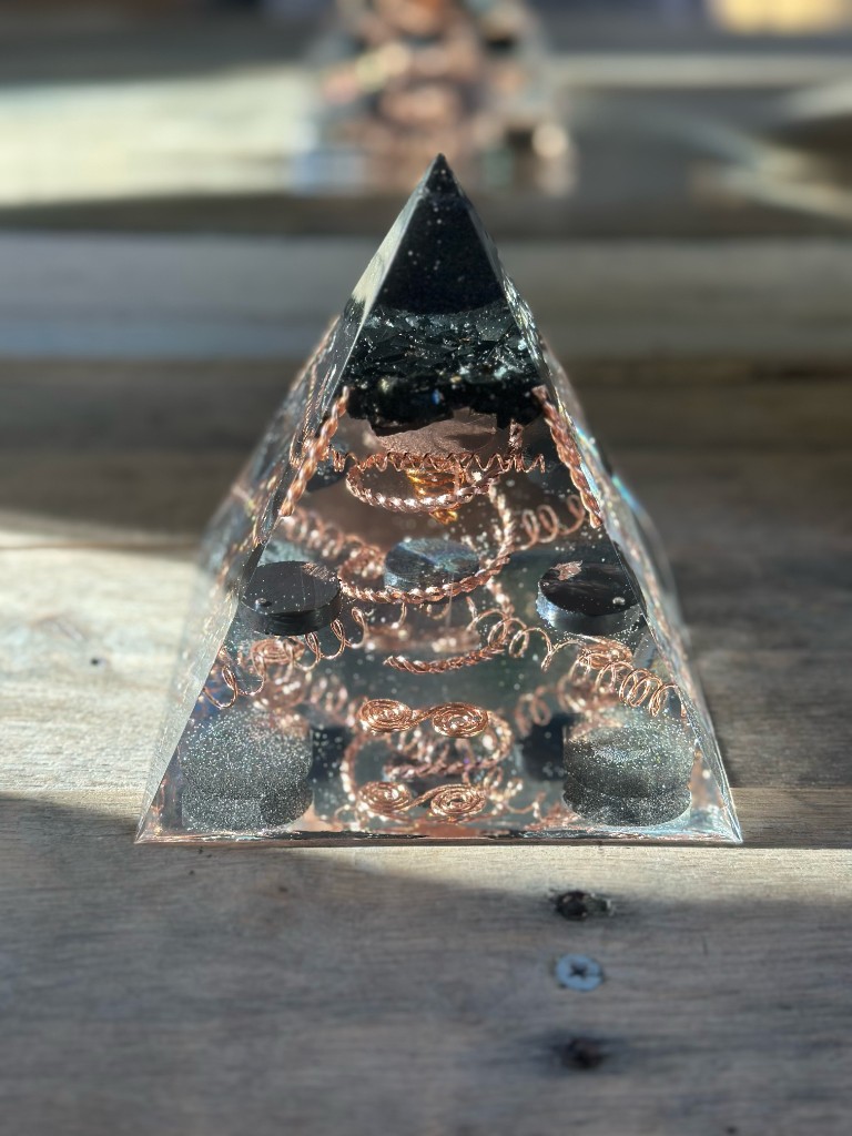 Small orgonite pyramid straight-on view with copper spirals